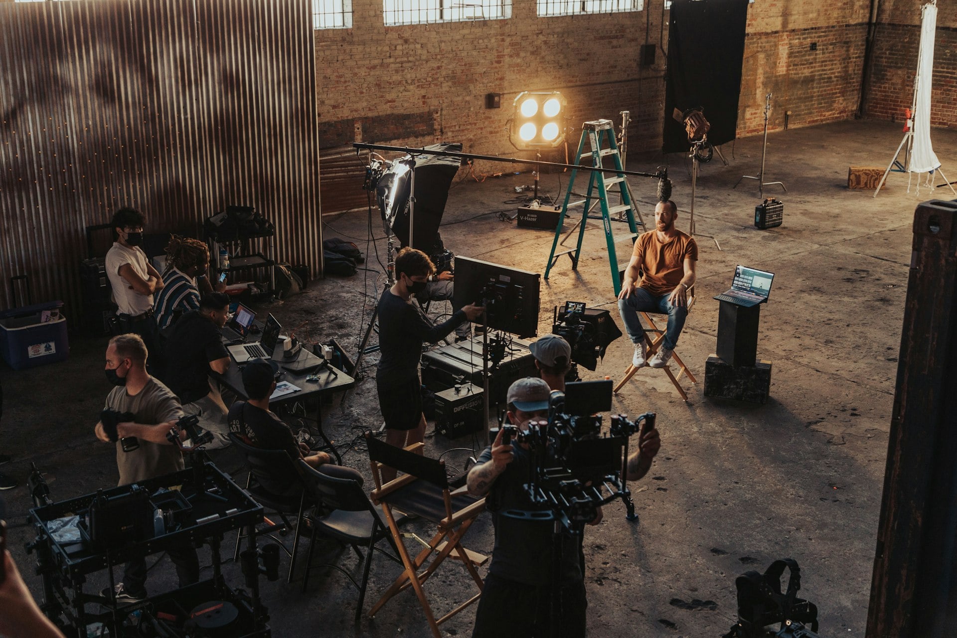 A small crew setting up cameras and lights for a shoot